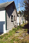 Driveway behind east side houses looking north to Kirby Smith Junior High on 10th